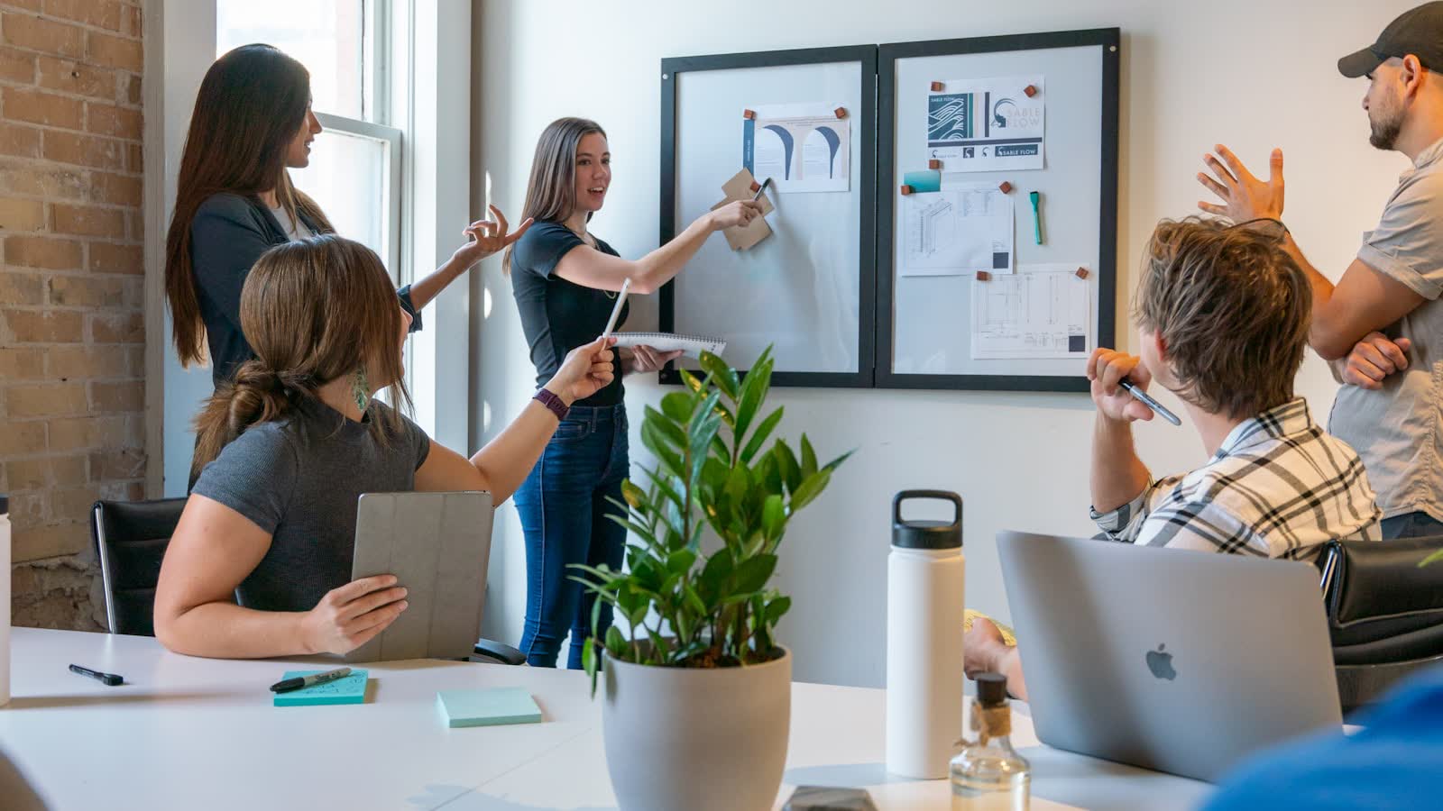 A small team working through a design problem together at a whiteboard